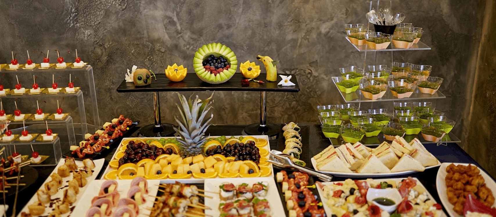 Grazing table with fruit carving and canapé platters